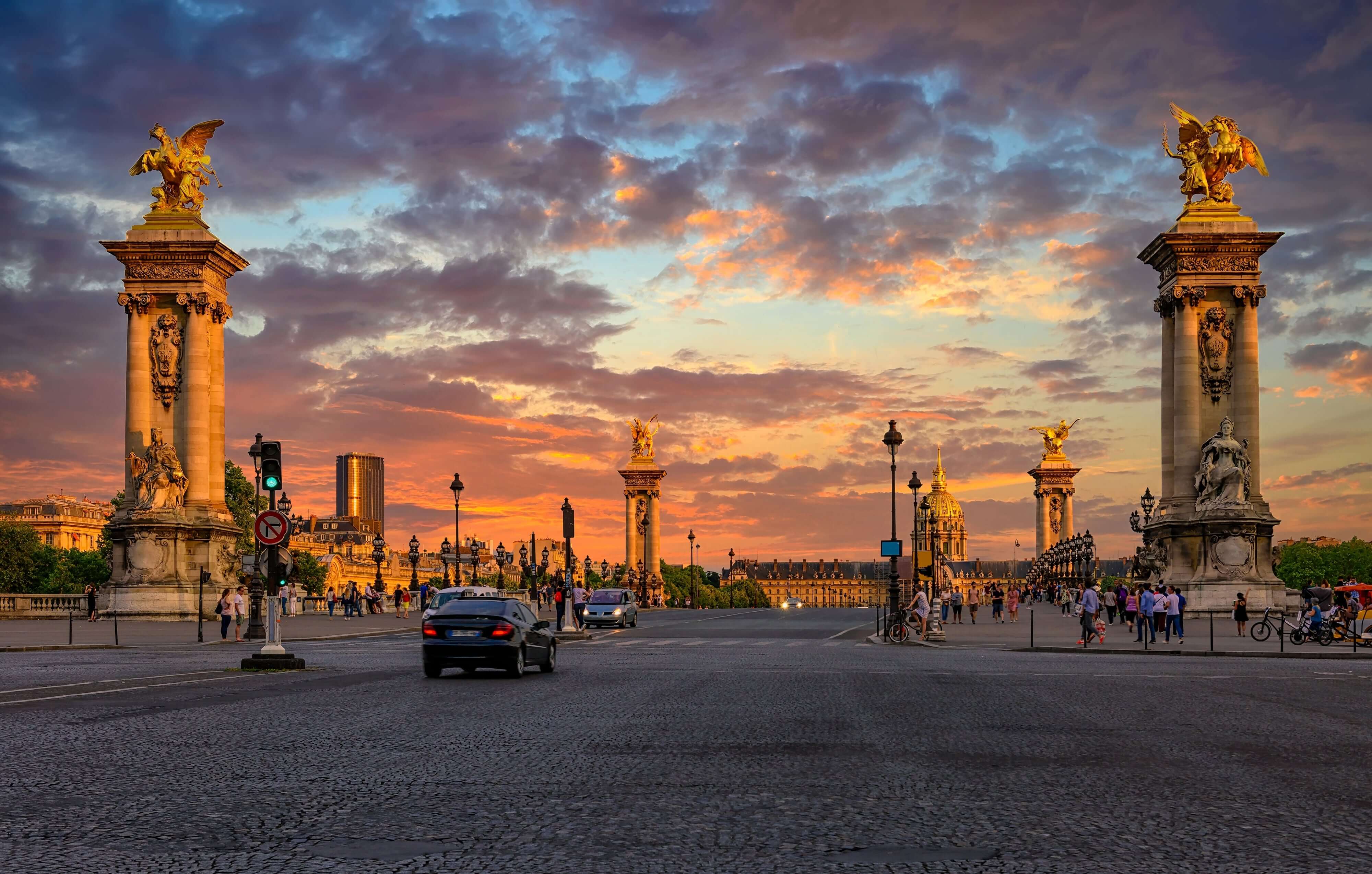 Pont Alexandre III bridge over river Seine and Hotel des Invalides on background at sunset in Paris, France. Cityscape of Paris. Architecture and landmarks of Paris.